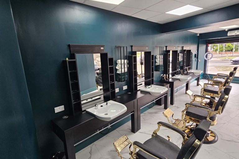 Chairs and mirrors inside 24/7 Barbers