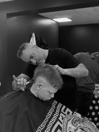 A barber at work at 24/7 Barbers